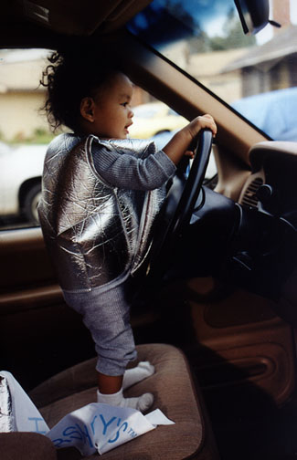 Mari plays in mom's new car