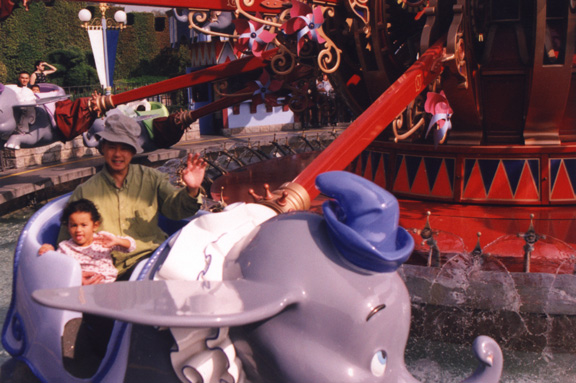 Mari goes on the Dumbo ride with dad!