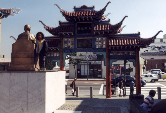 Mari poses with a statue of the founder of Chinatown!