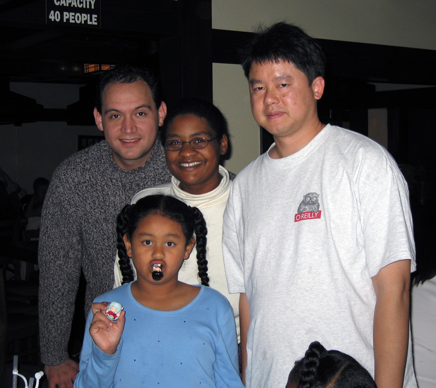 Mari poses with her mom, dad, and step-dad!