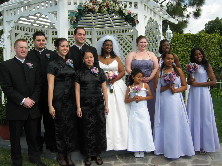 The wedding party poses for pictures outside!